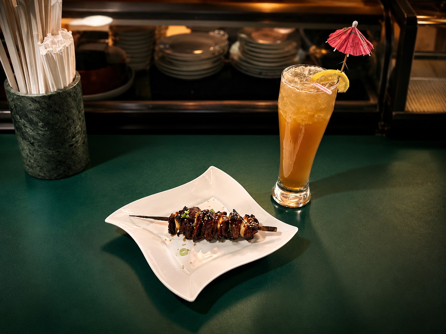 Grilled skewer and iced cocktail at the Suehiro sushi bar